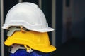 White, yellow and other colored safety helmets for workers` safety projects in the position of engineers or workers on concrete Royalty Free Stock Photo