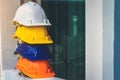 White, yellow and other colored safety helmets for workers` safety projects in the position of engineers or workers on concrete Royalty Free Stock Photo