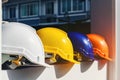 White, yellow and other colored safety helmets for workers` safety projects in the position of engineers or workers on concrete Royalty Free Stock Photo