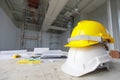 White and yellow safety helmet in construction site Royalty Free Stock Photo