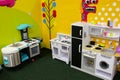 White and yellow toy kitchens. Games for girls in the entertainment center or in the house. Children free time. Retro play kitchen