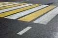 White Yellow Zebra Pedestrian Crossing On The Wet Asphalt Road