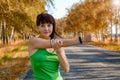 Fitness woman, wearing a smartwatch activity tracker, stretching her arms