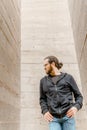 White young handsome man standing near the wall and look up. Portrait of fashion guy in blue jeans and casual wear smiling Royalty Free Stock Photo