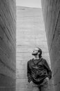 White young handsome man standing near the wall and look up. Portrait of fashion guy in blue jeans and casual wear smiling Royalty Free Stock Photo