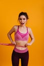 White young woman measuring her waiste. Lovely girl in sportswear holding measure tape Royalty Free Stock Photo