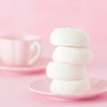 White zephyr dessrt on pink plate, cup of coffee with milk on pastel pink background. Beautiful sweets. Square banner, greeting ca Royalty Free Stock Photo