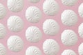 White zephyr marshmallows pattern on light pastel pink background Royalty Free Stock Photo