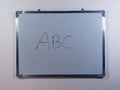 Whiteboard showing ABC concept on clean white wall background representing basic knowledge, learning and education Royalty Free Stock Photo