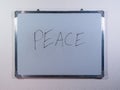 Whiteboard showing PEACE concept on clean white wall background representing harmony, calmness and global unity Royalty Free Stock Photo