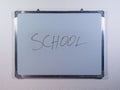 Whiteboard showing SCHOOL concept on clean white wall background representing education, learning and academic environment Royalty Free Stock Photo
