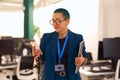 A whitecollar worker in formal wear holding a tablet and cell phone