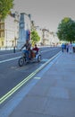 Pedicab with passengers travelling along Whitehall, London.