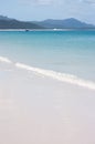 The Whitehaven Beach in the Whitsundays in Australia with a little boat in the distance