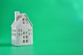 Whites small ceramic house model decorative see two surface on background green with space for text. Finance, sale, rent house