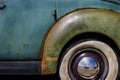 Closeup Of Whitewall Tires, Fender And Hubcap On Old Vintage Car With Peeling Paint