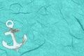 Whitewash wood anchor on teal textured cardstock paper background