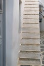 Whitewashed building stone stair, narrow cobblestone alley. Greek island. Cyclades Greece