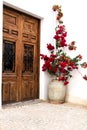 Whitewashed facade with old wooden door and bougainvillea in Altea Royalty Free Stock Photo