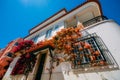 Whitewashed house in Cascais, Portugal covered in colourful bougainvillea