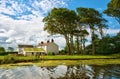 Whitewashed house next to a canal