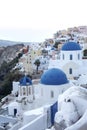 Whitewashed houses and blue dome church by the Aegean sea, Santoriniin Oia, Santorini, Greece. Famous blue domes in Oia village,