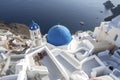 Whitewashed houses and blue dome church by the Aegean sea, Santoriniin Oia, Santorini, Greece. Famous blue domes in Oia village,