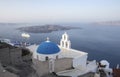 Whitewashed houses and blue dome church by the Aegean sea, Santoriniin Oia, Santorini, Greece. Famous blue domes in Oia village,