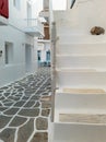 Whitewashed houses empty cobblestone alley at Naousa village, Paros island, Greece. Vertical Royalty Free Stock Photo