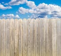 Private property, whitewashed rough wood fence with sunny blue sky and clouds Royalty Free Stock Photo