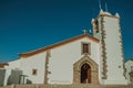 Whitewashed wall in old church with steeple and wooden door Royalty Free Stock Photo