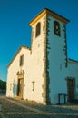 Whitewashed wall in old church with steeple and wooden door Royalty Free Stock Photo