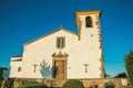 Whitewashed wall in old church with steeple and wooden door Royalty Free Stock Photo