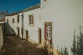 Whitewashed wall in old houses and cobblestone alley Royalty Free Stock Photo