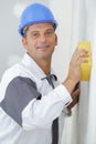 whitewasher man at work before plastering apartment house