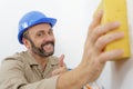 Whitewasher man at work plastering appartment