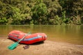 Whitewater rafting boat on shore of mountain river ready for adventure Royalty Free Stock Photo