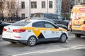 WhiteYandex taxi rides on the streets of Moscow in the flow of cars