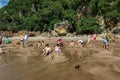 WHITIANGA, NZL - March 07 2016:Visitors making small hot water pools in Hot Water beach