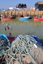 WHITSTABLE, UK - OCTOBER 15, 2017: Close-up on fishing nets at the fishing Harbor with fishing boats and wooden huts in the backgr