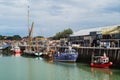 Colourful fishing boats and a thames barge in Whitstable harbour Royalty Free Stock Photo