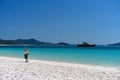 WHITSUNDAYS, AUSTRALIA - AUGUST 24TH: Male tourist with backpack enjoying the scenery and white silicon sand of Whitehaven Beach