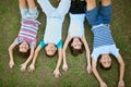 Who better to share a childhood with than siblings. High angle portrait of a group of happy siblings lying together on Royalty Free Stock Photo