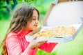 Who cares about diet. her favorite food. junk food concept. happy child hold big pizza. meal delivery in time. hungry Royalty Free Stock Photo