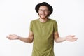 Who cares just chill. Studio shot of unbothered and relaxed handsome party hipster guy with beard in hat and glasses