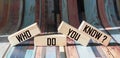 Who do you know symbol. Wooden blocks with the inscription who you know. Beautiful striped background.