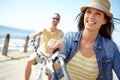 Who knew exercise could be so much fun. A happy young couple riding their bicycles on the promenade on a summers day. Royalty Free Stock Photo