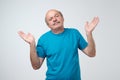 Who knows and it was not me concept. Puzzled bald caucasian man is not sure in his testimony. Royalty Free Stock Photo