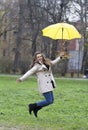 Who loves rain?She jumps on the grass in the park out of luck. Royalty Free Stock Photo