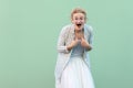 Who? me? Portrait of surprised young blonde woman in white striped blouse with eyeglasses standing, amazed face, pointing herself Royalty Free Stock Photo